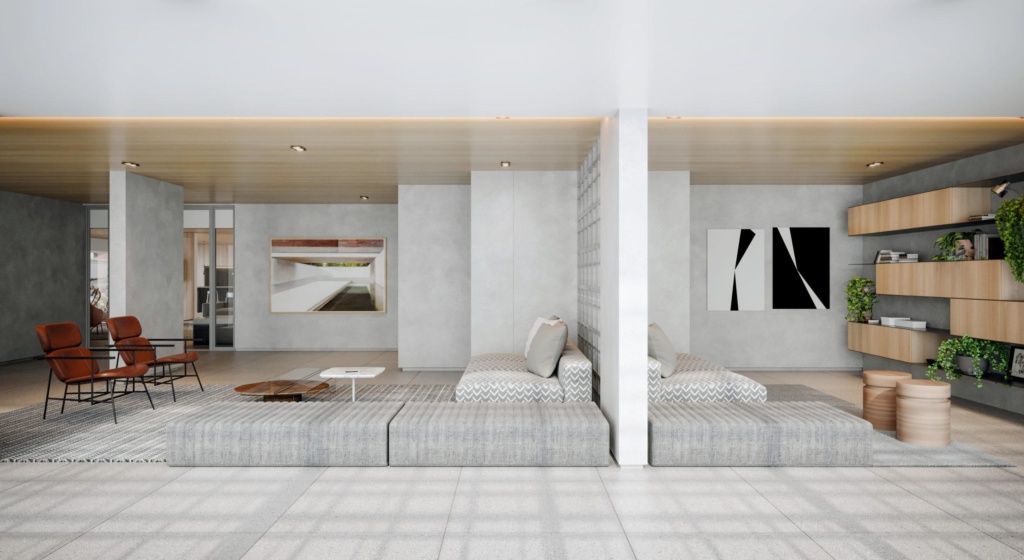 Ambiente amplo com duas cadeiras marrons, sofá cinza com almofadas e quadros decorativos nas paredes.